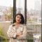 vertical-shot-young-woman-cream-coat-standing-terrace